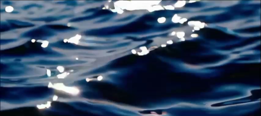 Sonnenlicht glitzert auf dunkelblauem Meerwasser.
